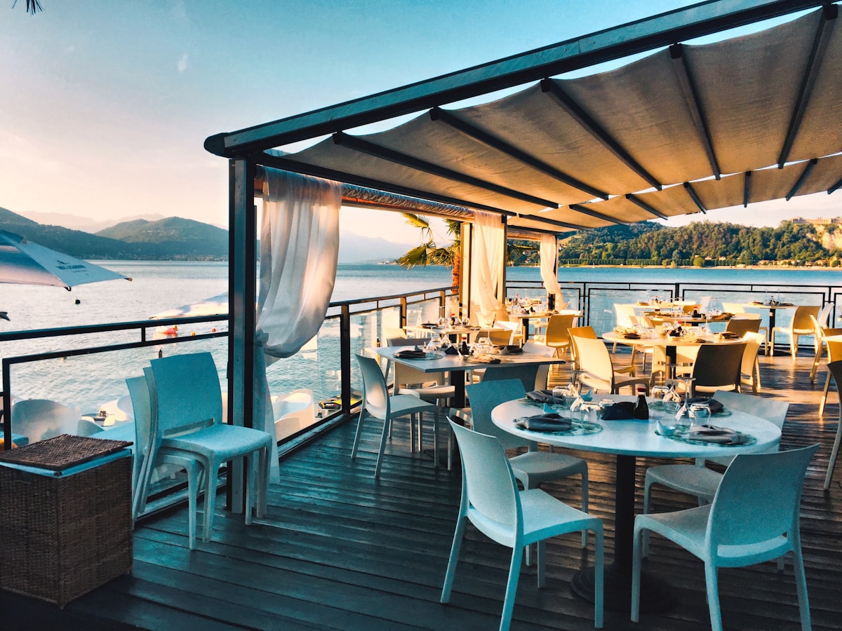 Waterfront dining terrace at The Clay Landing at sunset